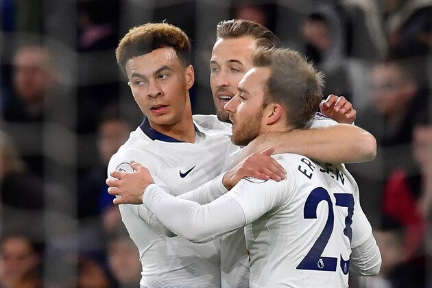 Tottenham Hotspur's Danish midfielder Christian Eriksen (R) celebrates scoring his team's second goal with Tottenham Hotspur's English striker Harry Kane and Tottenham Hotspur's English midfielder Dele Alli during the English Premier League football match between between Cardiff City and Tottenham Hotspur at Cardiff City Stadium in Cardiff, south Wales on  January 1, 2019. (Photo by Ben STANSALL / AFP) / RESTRICTED TO EDITORIAL USE. No use with unauthorized audio, video, data, fixture lists, club/league logos or 'live' services. Online in-match use limited to 120 images. An additional 40 images may be used in extra time. No video emulation. Social media in-match use limited to 120 images. An additional 40 images may be used in extra time. No use in betting publications, games or single club/league/player publications. /         (Photo credit should read BEN STANSALL/AFP/Getty Images)