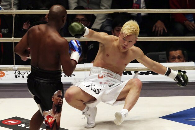 Japanese kickboxer Tenshin Nasukawa lies on the mat after being knocked out by Floyd Mayweather Jr. during first round of their three-round exhibition match on New Year's Eve, at Saitama Super Arena in Saitama, north of Tokyo, Monday, Dec. 31, 2018. (AP Photo/Koji Sasahara)