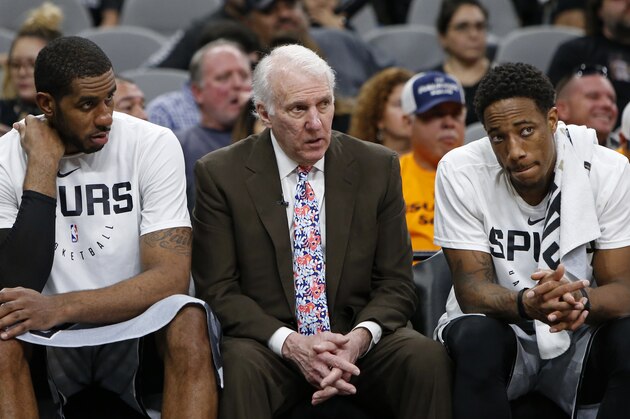 SAN ANTONIO, TX - NOVEMBER 30: Gregg Popovich head coach of the San Antonio Spurs talks with players LaMarcus Aldridge #12, and DeMar DeRozan #10 on the bench during an NBA game against the Houston Rockets held November 30, 2018 at the AT&T Center in San Antonio, Texas. The Houston Rockets won 136-105.  NOTE TO USER: User expressly acknowledges and agrees that, by downloading and or using this photograph, User is consenting to the terms and conditions of the Getty Images License Agreement.  (Photo by Edward A. Ornelas/Getty Images)