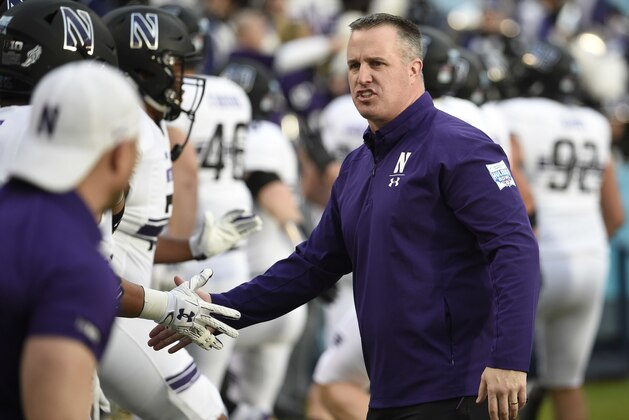 Northwestern head coach Pat Fitzgerald, right, greets players before the Holiday Bowl NCAA college football game against Utah, Monday, Dec. 31, 2018, in San Diego. (AP Photo/Denis Poroy)