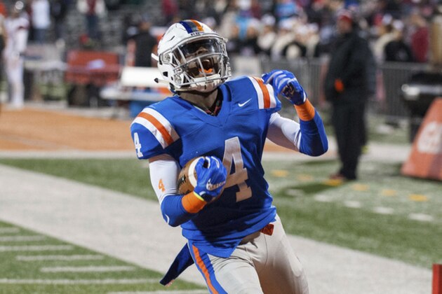 FILE - In this Nov. 26, 2016 photo, East St. Louis's Jeff Thomas reacts after his touchdown reception during the third quarter of the IHSA Class 7A high school championship football game against Plainfield North at Memorial Stadium in Champaign, Ill. Thomas, who scored two touchdowns in the Under Armour All-Star game could wind up in Miami, but Illinois and Missouri are scrambling to keep him closer to home. (AP Photo/Bradley Leeb, File0