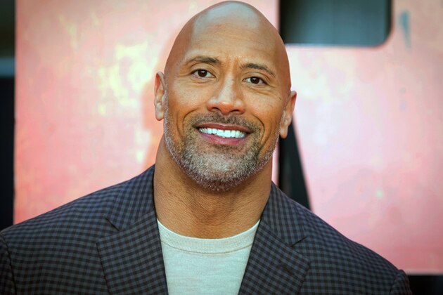 FILE - In this April 11, 2018, file photo, actor Dwayne Johnson poses for photographers at the premiere of the