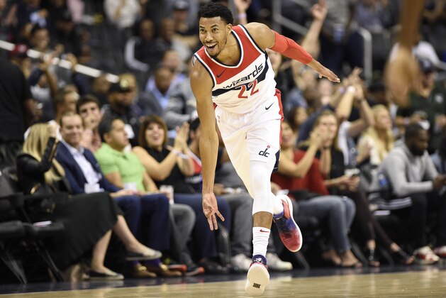 Washington Wizards forward Otto Porter Jr. reacts after he made a three-point basket during the first half of an NBA preseason basketball game against the Miami Heat, Friday, Oct. 5, 2018, in Washington. (AP Photo/Nick Wass)