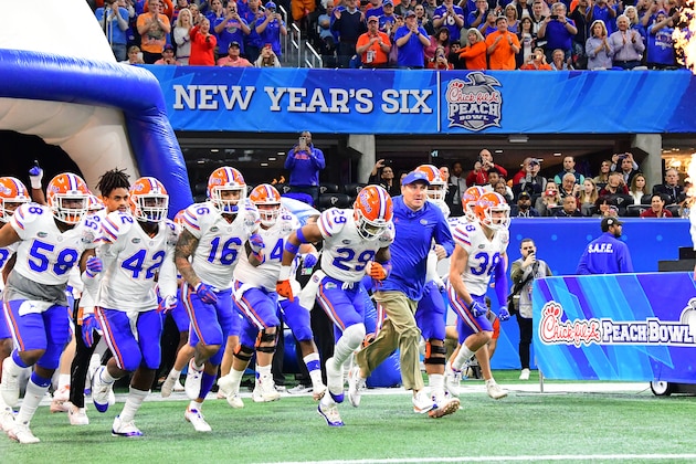 ATLANTA, GEORGIA - DECEMBER 29:  Head coach Dan Mullen of the Florida Gators leads his team out of the tunnel prior to the Chick-fil-A Peach Bowl against the Michigan Wolverines at Mercedes-Benz Stadium on December 29, 2018 in Atlanta, Georgia. (Photo by Scott Cunningham/Getty Images)