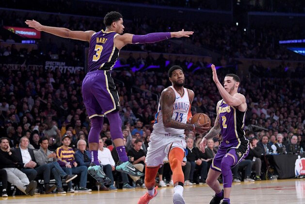 LOS ANGELES, CALIFORNIA - JANUARY 02:   Paul George #13 of the Oklahoma City Thunder drives to the basket between Josh Hart #3 and Lonzo Ball #2 of the Los Angeles Lakers during the first half  at Staples Center on January 02, 2019 in Los Angeles, California.  NOTE TO USER: User expressly acknowledges and agrees that, by downloading and or using this photograph, User is consenting to the terms and conditions of the Getty Images License Agreement. (Photo by Harry How/Getty Images)
