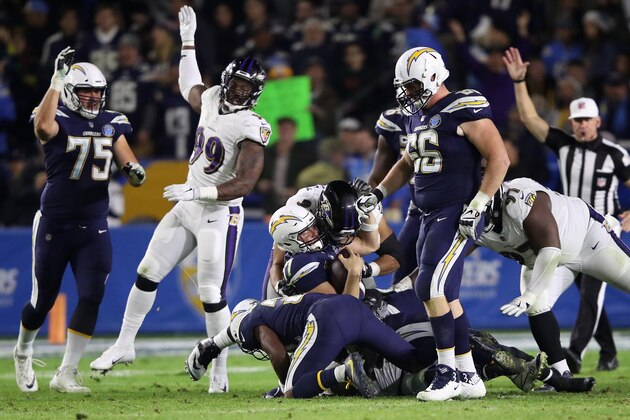 CARSON, CA - DECEMBER 22:  Chris Wormley #93 of the Baltimore Ravens sacks Philip Rivers #17 as Dan Feeney #66 and Michael Schofield #75 of the Los Angeles Chargers look on during the second half of a game at StubHub Center on December 22, 2018 in Carson, California.  (Photo by Sean M. Haffey/Getty Images)