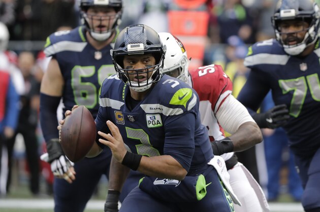 Seattle Seahawks quarterback Russell Wilson scrambles with the ball during the first half of an NFL football game against the Arizona Cardinals, Sunday, Dec. 30, 2018, in Seattle. (AP Photo/Ted S. Warren)
