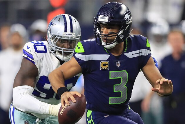ARLINGTON, TX - DECEMBER 24:  Russell Wilson #3 of the Seattle Seahawks runs away from DeMarcus Lawrence #90 of the Dallas Cowboys in the second half at AT&T Stadium on December 24, 2017 in Arlington, Texas.  (Photo by Ronald Martinez/Getty Images)