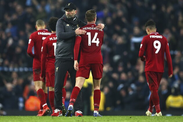 Liverpool's coach Juergen Klopp speaks to his player after his team lost the English Premier League soccer match between Manchester City and Liverpool at the Etihad Stadium in Manchester, England, Thursday, Jan. 3, 2019.(AP Photo/Dave Thompson)