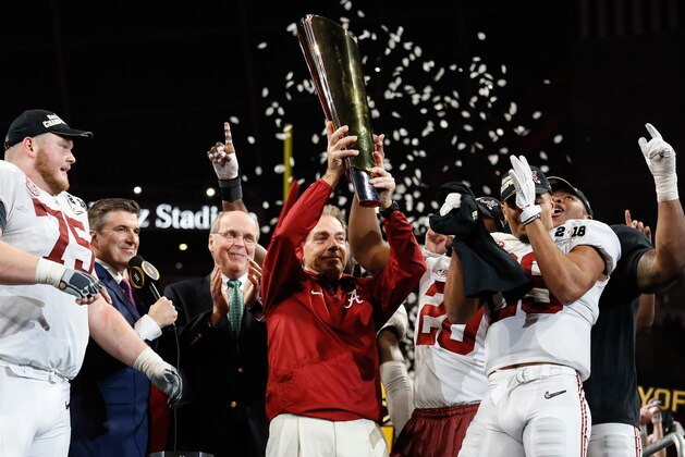 ATLANTA, GA - JANUARY 08:  Head coach Nick Saban of the Alabama Crimson Tide holds the trophy while celebrating with his team after defeating the Georgia Bulldogs in overtime to win the CFP National Championship presented by AT&T at Mercedes-Benz Stadium on January 8, 2018 in Atlanta, Georgia.  (Photo by Jamie Squire/Getty Images)