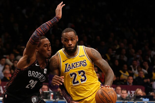 BROOKLYN, NY - DECEMBER 18:  (NEW YORK DAILIES OUT)    LeBron James #23 of the Los Angeles Lakers in action against Rondae Hollis-Jefferson #24 of the Brooklyn Nets at Barclays Center on December 18, 2018 in the Brooklyn borough of New York City.  The Nets defeated the Lakers 115-110. NOTE TO USER: User expressly acknowledges and agrees that, by downloading and/or using this photograph, user is consenting to the terms and conditions of the Getty Images License Agreement.  (Photo by Jim McIsaac/Getty Images)