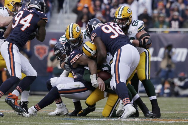 Chicago Bears linebacker Khalil Mack, left, and defensive tackle Bilal Nichols (98) sack Green Bay Packers quarterback Aaron Rodgers (12) during the first half of an NFL football game Sunday, Dec. 16, 2018, in Chicago. (AP Photo/David Banks)
