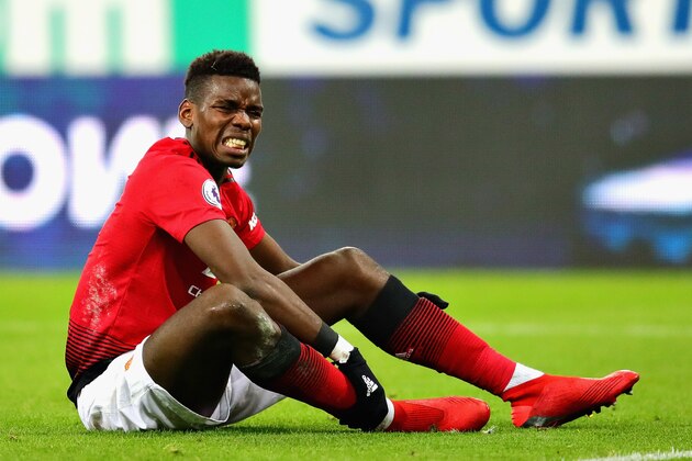 NEWCASTLE UPON TYNE, ENGLAND - JANUARY 02:  Paul Pogba of Manchester United holds his leg after a challenge during the Premier League match between Newcastle United and Manchester United at St. James Park on January 2, 2019 in Newcastle upon Tyne, United Kingdom.  (Photo by Chris Brunskill/Fantasista/Getty Images)