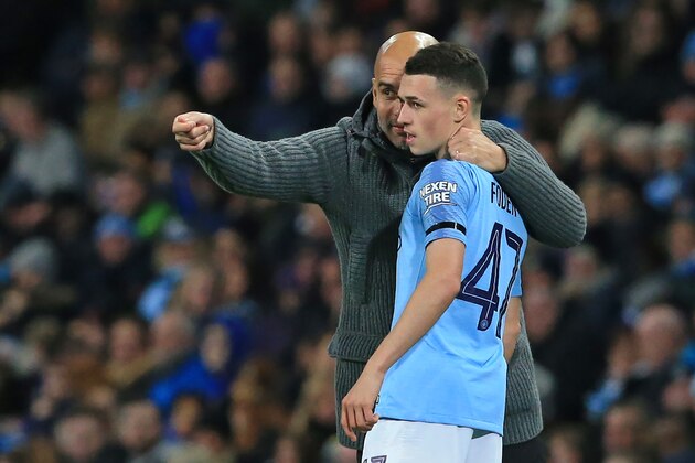 Manchester City's Spanish manager Pep Guardiola (L) speaks with Manchester City's English midfielder Phil Foden (R) during the English League Cup, 4th round football match between Manchester City and Fulham at the Etihad Stadium in Manchester, north west England, on November 1, 2018. (Photo by Lindsey PARNABY / AFP) / RESTRICTED TO EDITORIAL USE. No use with unauthorized audio, video, data, fixture lists, club/league logos or 'live' services. Online in-match use limited to 120 images. An additional 40 images may be used in extra time. No video emulation. Social media in-match use limited to 120 images. An additional 40 images may be used in extra time. No use in betting publications, games or single club/league/player publications. / (Photo credit should read LINDSEY PARNABY/AFP/Getty Images) Manchester City's Spanish manager Pep Guardiola (L) speaks with Manchester City's English midfielder Phil Foden (R) during the English League Cup, 4th round football match between Manchester City and Fulham at the Etihad Stadium in Manchester, north west England, on November 1, 2018. (Photo by Lindsey PARNABY / AFP) / RESTRICTED TO EDITORIAL USE. No use with unauthorized audio, video, data, fixture lists, club/league logos or 'live' services. Online in-match use limited to 120 images. An additional 40 images may be used in extra time. No video emulation. Social media in-match use limited to 120 images. An additional 40 images may be used in extra time. No use in betting publications, games or single club/league/player publications. / (Photo credit should read LINDSEY PARNABY/AFP/Getty Images)