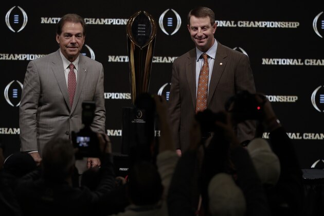 Alabama head coach Nick Saban and Clemson head coach Dabo Swinney pose with the trophy at a news conference for the NCAA college football playoff championship game Sunday, Jan. 6, 2019, in Santa Clara, Calif. (AP Photo/Chris Carlson)