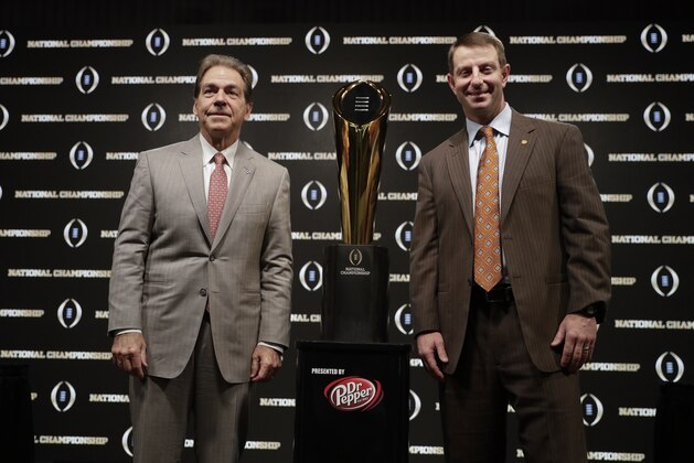 Alabama head coach Nick Saban and Clemson head coach Dabo Swinney pose with the trophy at a news conference for the NCAA college football playoff championship game Sunday, Jan. 6, 2019, in Santa Clara, Calif. (AP Photo/David J. Phillip)