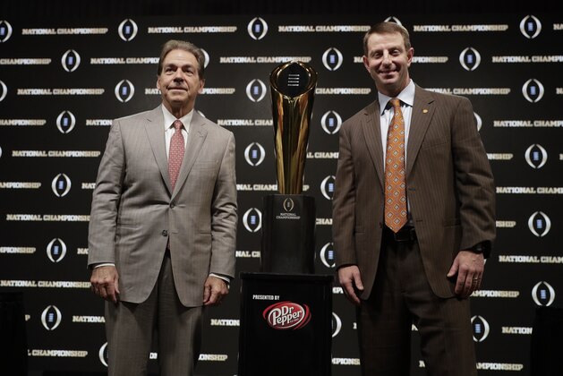 Alabama head coach Nick Saban and Clemson head coach Dabo Swinney pose with the trophy at a news conference for the NCAA college football playoff championship game Sunday, Jan. 6, 2019, in Santa Clara, Calif. (AP Photo/David J. Phillip)