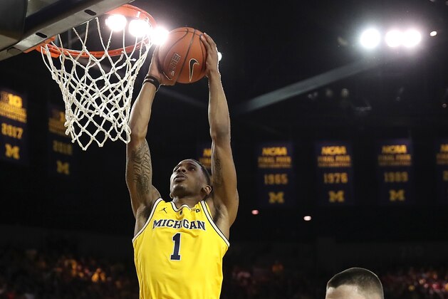 ANN ARBOR, MICHIGAN - JANUARY 06:  Charles Matthews #1 of the Michigan Wolverines dunks next to Zach McRoberts #15 of the Indiana Hoosiers during the first half at Crisler Arena on January 06, 2019 in Ann Arbor, Michigan. (Photo by Gregory Shamus/Getty Images)