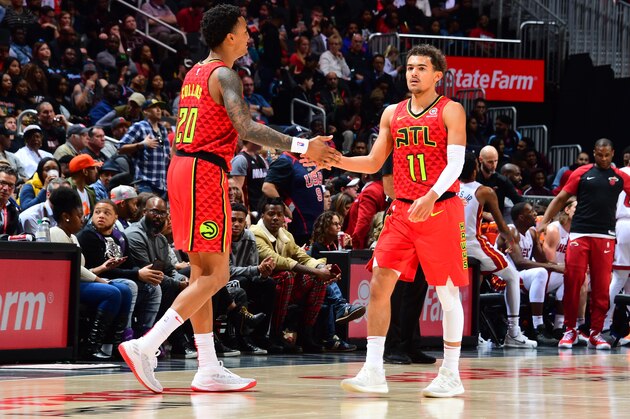 ATLANTA, GA - JANUARY 6: John Collins #20 and Trae Young #11 of the Atlanta Hawks high-five during a game against the Miami Heat on January 6, 2019 at State Farm Arena in Atlanta, Georgia.  NOTE TO USER: User expressly acknowledges and agrees that, by downloading and/or using this Photograph, user is consenting to the terms and conditions of the Getty Images License Agreement. Mandatory Copyright Notice: Copyright 2019 NBAE (Photo by Scott Cunningham/NBAE via Getty Images)