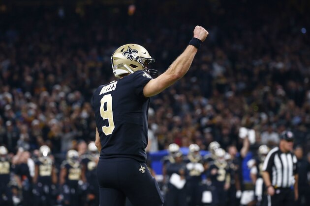 New Orleans Saints quarterback Drew Brees (9) celebrates a touchdown by running back Alvin Kamara, not pictured, in the first half of an NFL football game in New Orleans, Sunday, Dec. 23, 2018. The Saints won 31-28, clinching the top seed for the NFC and home field advantage for the playoffs. (AP Photo/Butch Dill)