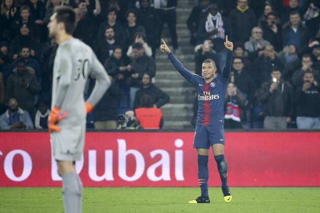 PARIS, FRANCE - DECEMBER 22: Kylian Mbappe of PSG celebrates his goal while goalkeeper of FC Nantes Anton Ciprian Tatarusanu looks on during the french Ligue 1 match between Paris Saint-Germain (PSG) and FC Nantes at Parc des Princes stadium on December 22, 2018 in Paris, France. (Photo by Jean Catuffe/Getty Images)
