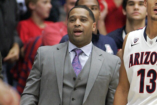 Arizona's assistant coach Book Richardson, left, and Nick Johnson (13) stand and watch the game from the bench as Arizona plays New Mexico State in the second half of an NCAA college basketball game on Wednesday, Dec. 11, 2013 in Tucson, Ariz. (AP Photo/John MIller)