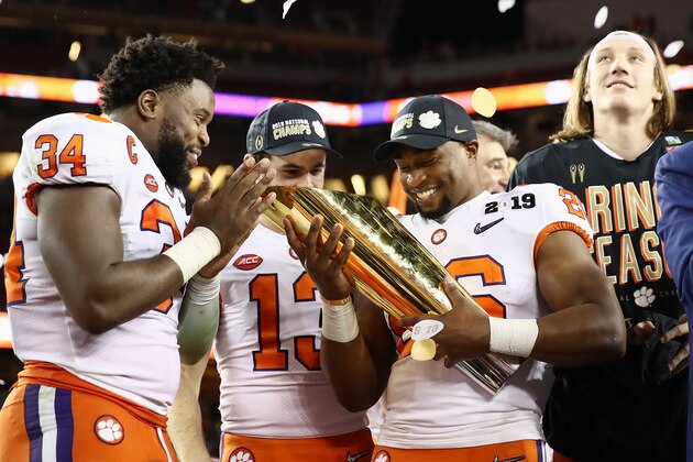 SANTA CLARA, CA - JANUARY 07:  Kendall Joseph #34, Hunter Renfrow #13 and Adam Choice #26 of the Clemson Tigers celebrate with the trophy after their 44-16 win over the Alabama Crimson Tide in the CFP National Championship presented by AT&T at Levi's Stadium on January 7, 2019 in Santa Clara, California.  (Photo by Ezra Shaw/Getty Images)
