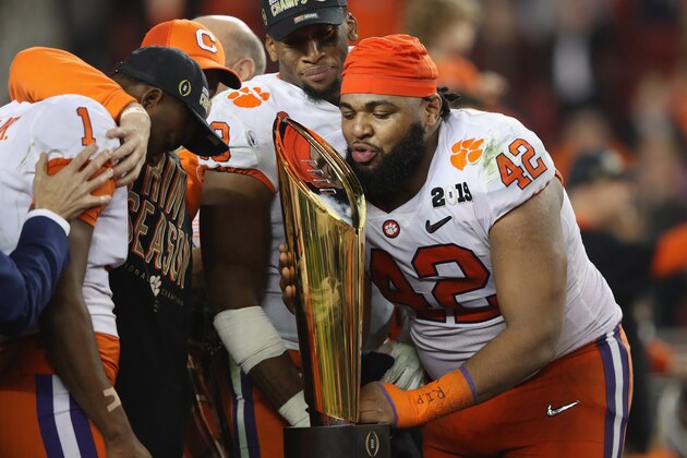 SANTA CLARA, CA - JANUARY 07:  Christian Wilkins #42 of the Clemson Tigers celebrates with the trophy after his teams 44-16 win over the Alabama Crimson Tide in the CFP National Championship presented by AT&T at Levi's Stadium on January 7, 2019 in Santa Clara, California.  (Photo by Sean M. Haffey/Getty Images)