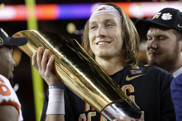 Clemson's Trevor Lawrence holds the trophy after the NCAA college football playoff championship game against Alabama, Monday, Jan. 7, 2019, in Santa Clara, Calif. Clemson beat Alabama 44-16. (AP Photo/David J. Phillip)