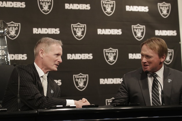 Mike Mayock, left, shakes hands with Oakland Raiders head coach Jon Gruden at a news conference announcing Mayock as the team's general manager in Oakland, Calif., Monday, Dec. 31, 2018. (AP Photo/Jeff Chiu)