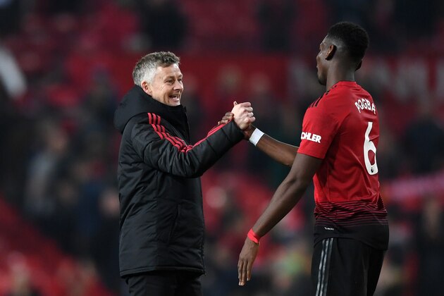 MANCHESTER, ENGLAND - DECEMBER 26:  Ole Gunnar Solskjaer, Interim Manager of Manchester United and Paul Pogba of Manchester United celebrate following their sides victory in the Premier League match between Manchester United and Huddersfield Town at Old Trafford on December 26, 2018 in Manchester, United Kingdom.  (Photo by Gareth Copley/Getty Images)