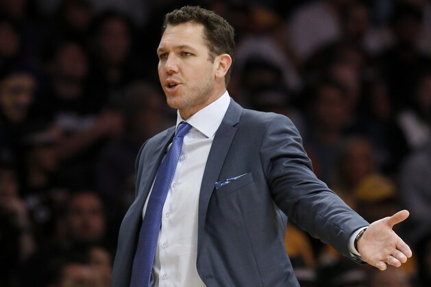 Los Angeles Lakers head coach Luke Walton talks with a referee during the first half of an NBA basketball game against the Sacramento Kings in Los Angeles, Sunday, Dec. 30, 2018. (AP Photo/Alex Gallardo)
