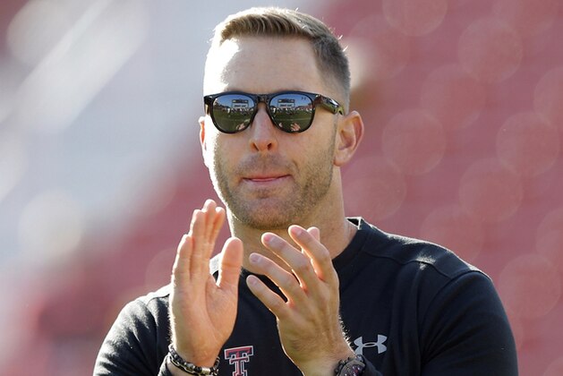 FILE- In this Oct. 27, 2018, file photo, Texas Tech head coach Kliff Kingsbury stands on the field before an NCAA college football game against Iowa State in Ames, Iowa.  Kingsbury has agreed to become Clay Helton’s offensive coordinator and quarterbacks coach at Southern California, USC announced Wednesday, Dec. 5, 2018. Kingsbury is considered one of the top offensive minds in football despite being fired by Texas Tech on Nov. 25. (AP Photo/Charlie Neibergall, File)