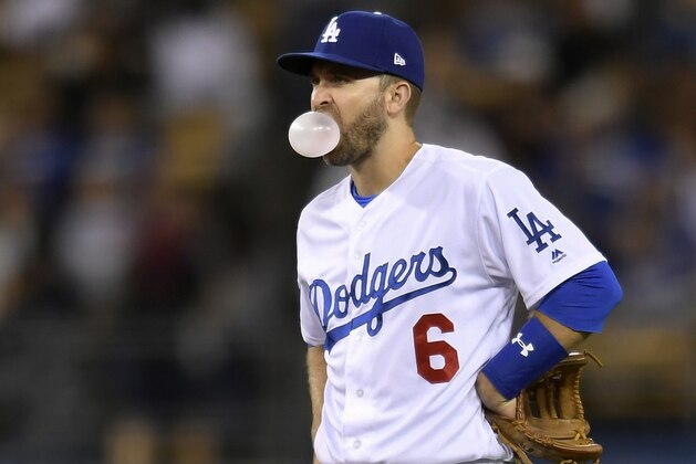 Los Angeles Dodgers second baseman Brian Dozier blows a bubble during the second inning of a baseball game against the New York Mets Tuesday, Sept. 4, 2018, in Los Angeles.The Dodgers won 11-4. (AP Photo/John McCoy)