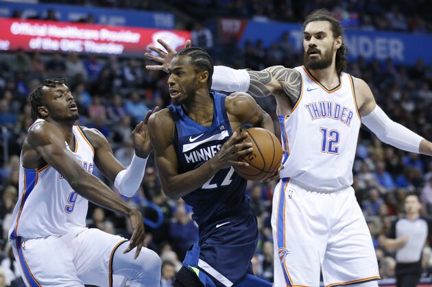 Minnesota Timberwolves forward Andrew Wiggins (22) drives between Oklahoma City Thunder forward Jerami Grant (9) and center Steven Adams (12) in the first half of an NBA basketball game in Oklahoma City, Tuesday, Jan. 8, 2019. (AP Photo/Sue Ogrocki) Minnesota Timberwolves forward Andrew Wiggins (22) drives between Oklahoma City Thunder forward Jerami Grant (9) and center Steven Adams (12) in the first half of an NBA basketball game in Oklahoma City, Tuesday, Jan. 8, 2019. (AP Photo/Sue Ogrocki)