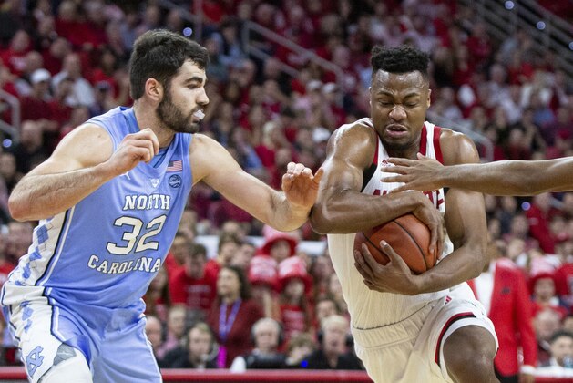 North Carolina State's Torin Dorn, right, drives against North Carolina's Luke Maye (32) during the first half of an NCAA college basketball game in Raleigh, N.C., Tuesday, Jan. 8, 2019. (AP Photo/Ben McKeown)