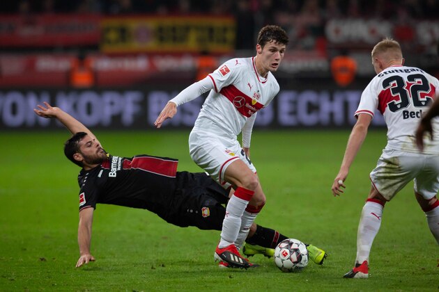 LEVERKUSEN, GERMANY - NOVEMBER 23: Kevin Volland of Leverkusen and Benjamin Pavard of Stuttgart battle for the ball during the Bundesliga match between Bayer 04 Leverkusen and VfB Stuttgart at BayArena on November 23, 2018 in Leverkusen, Germany. (Photo by TF-Images/Getty Images)