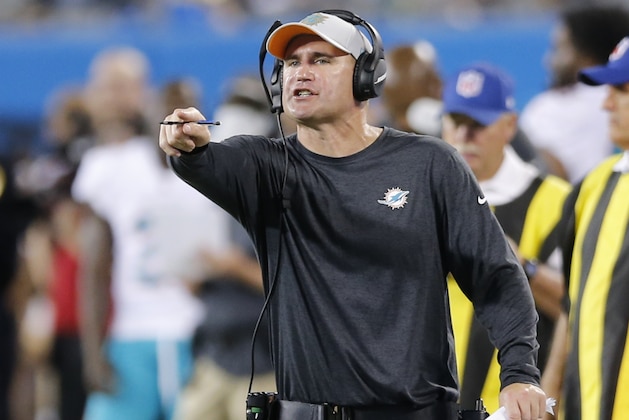 Miami Dolphins associate head coach/special teams coordinator Darren Rizzi directs his team against the Carolina Panthers in the first half of a preseason NFL football game in Charlotte, N.C., Friday, Aug. 17, 2018. (AP Photo/Nell Redmond)
