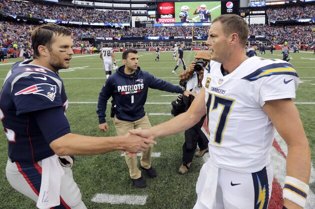 New England Patriots quarterback Tom Brady (12) andLos Angeles Chargers quarterback Philip Rivers (17) speak at midfield after an NFL football game, Sunday, Oct. 29, 2017, in Foxborough, Mass. (AP Photo/Steven Senne)