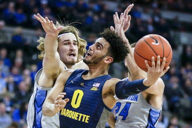 Marquette's Markus Howard (0) goes to the basket in front of Creighton's Samson Froling, left, during the first half of an NCAA college basketball game in Omaha, Neb., Wednesday, Jan. 9, 2019. (AP Photo/Nati Harnik)