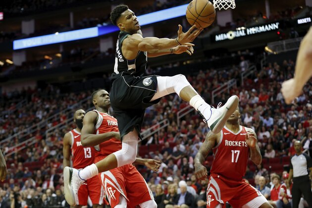 HOUSTON, TX - JANUARY 09:  Giannis Antetokounmpo #34 of the Milwaukee Bucks goes up for a shot defended byDanuel House Jr. #4 of the Houston Rockets and PJ Tucker #17 in the first half at Toyota Center on January 9, 2019 in Houston, Texas.  NOTE TO USER: User expressly acknowledges and agrees that, by downloading and or using this photograph, User is consenting to the terms and conditions of the Getty Images License Agreement.  (Photo by Tim Warner/Getty Images)