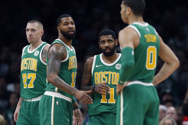 Boston Celtics' Daniel Theis (27), Marcus Morris (13), Kyrie Irving (11) and Jayson Tatum (0) on the court during the second half of an NBA basketball game against the Philadelphia 76ers in Boston, Tuesday, Dec. 25, 2018. (AP Photo/Michael Dwyer)