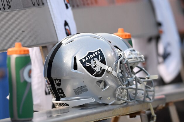 OAKLAND, CA - AUGUST 24:  A detailed view of helmets belonging to the Oakland Raiders sitting on the bench during the singing of the National Anthem prior to the start of a NFL preseason football game against the Green Bay Packers at Oakland-Alameda County Coliseum on August 24, 2018 in Oakland, California.  (Photo by Thearon W. Henderson/Getty Images)