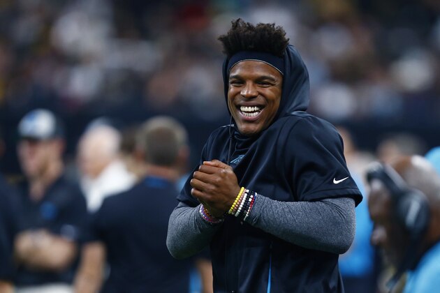 Carolina Panthers quarterback Cam Newton, who was inactive for the game, celebrates a touchdown reception from the sideline in the first half of an NFL football game against the New Orleans Saints in New Orleans, Sunday, Dec. 30, 2018. (AP Photo/Butch Dill)