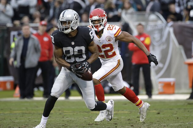 Oakland Raiders wide receiver Amari Cooper (89) runs in front of Kansas City Chiefs cornerback Marcus Peters (22) during the second half of an NFL football game in Oakland, Calif., Sunday, Dec. 6, 2015. (AP Photo/Marcio Jose Sanchez)