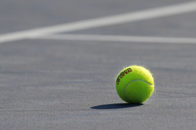 A tennis ball is shown on a court during the third round of play at the 2012 US Open tennis tournament,  Friday, Aug. 31, 2012, in New York. (AP Photo/Paul Bereswill)