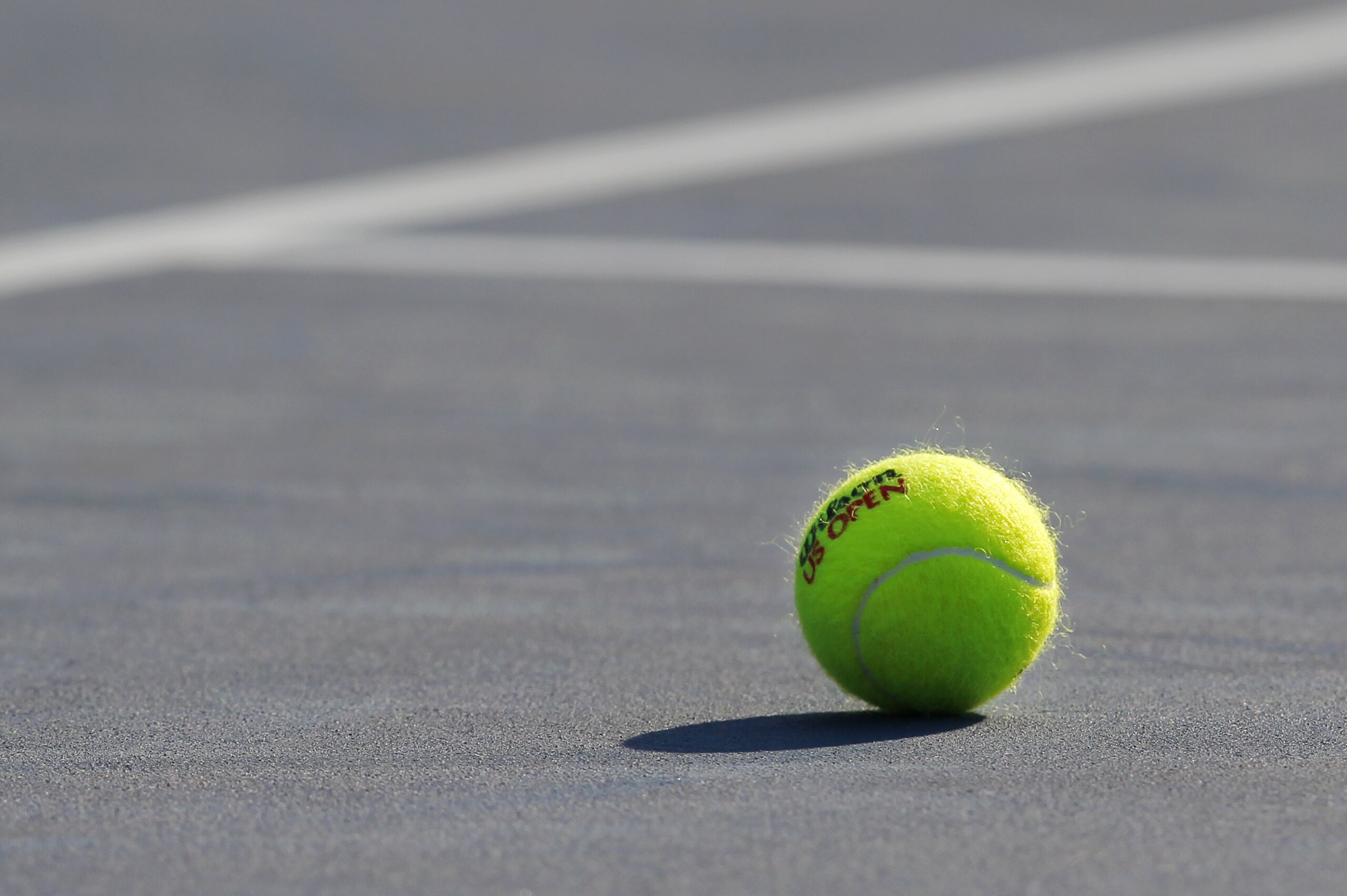 A tennis ball is shown on a court during the third round of play at the 2012 US Open tennis tournament,  Friday, Aug. 31, 2012, in New York. (AP Photo/Paul Bereswill)