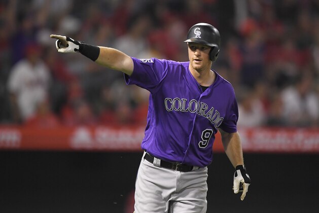 Colorado Rockies' DJ LeMahieu gestures toward his dugout as he runs to first after hitting a grand slam during the eighth inning of a baseball game against the Los Angeles Angels, Monday, Aug. 27, 2018, in Anaheim, Calif. (AP Photo/Mark J. Terrill)