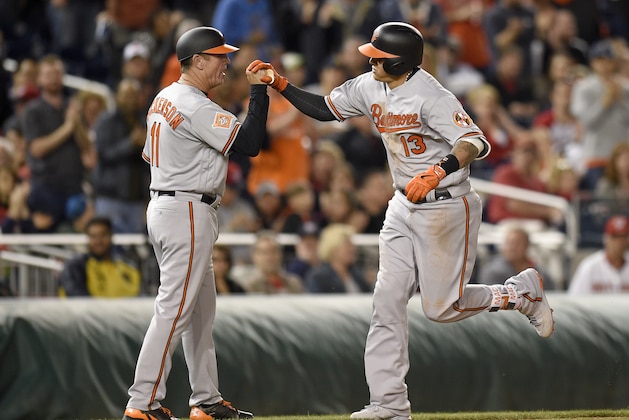 Baltimore Orioles' Manny Machado is greeted by third base coach Bobby Dickerson (11) after his home run during an interleague baseball game against the Washington Nationals, Wednesday, May 10, 2017, in Washington. The Nationals won 7-6. (AP Photo/Nick Wass)