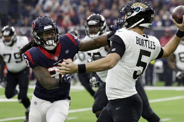Jacksonville Jaguars quarterback Blake Bortles (5) is pressured by Houston Texans outside linebacker Jadeveon Clowney (90) during the first half of an NFL football game, Sunday, Dec. 30, 2018, in Houston. (AP Photo/David J. Phillip)
